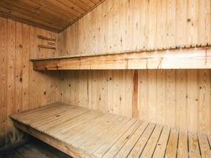 a wooden sauna with a wooden bench in it at 8 person holiday home in Ørsted in Kare