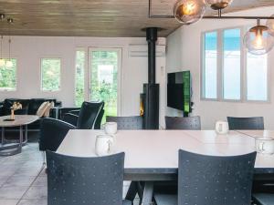 a dining room with a white table and chairs at 8 person holiday home in Ørsted in Kare +32 photos