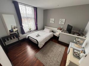 a small bedroom with a bed and a window at Breeze Guest House in Bootle +18 photos