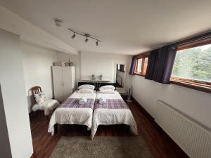 a bedroom with two beds and a window at Breeze Guest House in Bootle