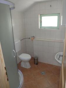a bathroom with a toilet and a sink at Holiday Home Rizvan City in Brušane +11 photos