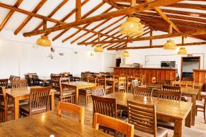 a dining room with wooden tables and chairs at Hotel las Palmas in Villa de Leyva