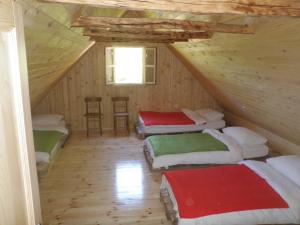 a room with four beds in a attic at Holiday Home Rizvan City in Brušane