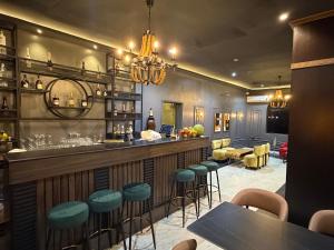 a bar with blue stools in a restaurant at de brit hotel in Benin City