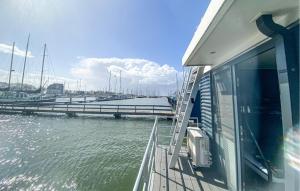 a boat is docked at a dock in the water at 2 Bedroom Nice Ship In Lelystad in Lelystad