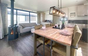 a kitchen and dining room with a table and a fireplace at 2 Bedroom Nice Ship In Lelystad in Lelystad