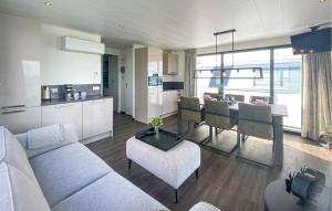 a living room with a couch and a dining room at 2 Bedroom Nice Ship In Lelystad in Lelystad