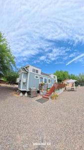 a mobile home sitting on top of a gravel lot at Horseshoe Tiny home in Scottsdale
