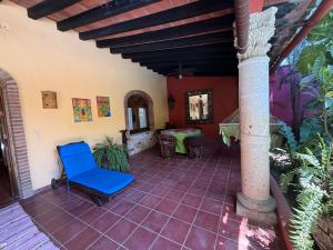 a room with a blue chair on a patio at Casa Sorpresa in Sayulita