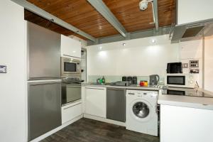 a kitchen with a washer and dryer at City Centre Apartment in Nottingham