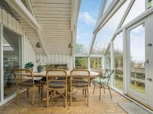 a screened in porch with a table and chairs at 4 star holiday home in Asnæs in Asnæs