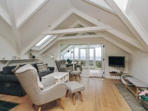 a living room with a couch and a tv at 4 star holiday home in Asnæs in Asnæs