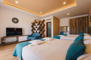 a hotel room with two beds and a flat screen tv at Apartments Kan in Ulcinj +68 photos