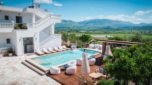a villa with a swimming pool and mountains in the background at Villa JOSANA in Sarandë +57 photos