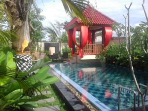 a resort with a pool and a gazebo at Villa Rosseno - Evelyn Private pool and Garden in Yogyakarta