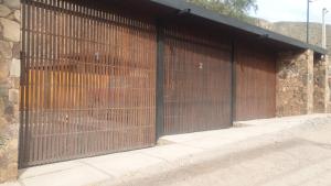 a large wooden gate in a stone building at Tierra Viva in Purmamarca