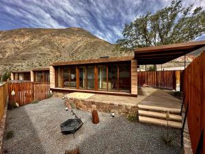 a house in front of a mountain at Tierra Viva in Purmamarca