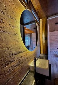 a bathroom with a mirror and a sink at Tierra Viva in Purmamarca