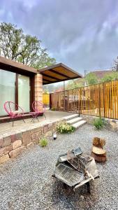 a backyard with a house with a table and chairs at Tierra Viva in Purmamarca