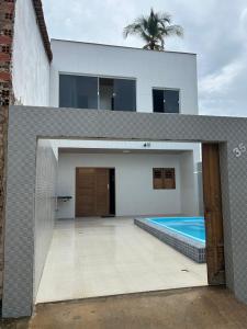 a house with a swimming pool in front of it at Maria Luiza da silva in Japaratinga