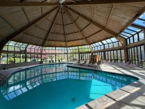 an indoor swimming pool with a large roof at Ski-OnSki-Off Camelback Arcade Pool in Tannersville