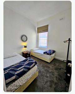 a bedroom with two beds and a window at Euro Nomads in Melbourne