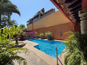 a swimming pool in front of a building at Casa Sorpresa in Sayulita