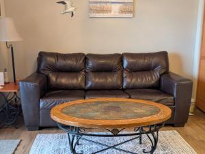 a brown leather couch with a coffee table in a living room at C & D Restawhile in Oak Harbor