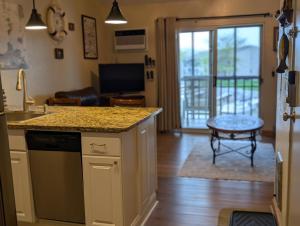 a kitchen with a counter and a living room at C & D Restawhile in Oak Harbor
