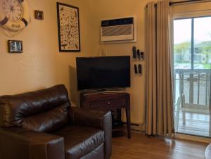 a living room with a couch and a flat screen tv at C & D Restawhile in Oak Harbor