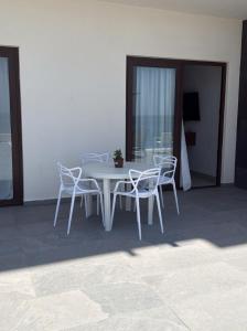 a white table and chairs on a patio at Apartamento en Punta Mita in Higuera Blanca