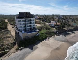 an aerial view of a building on the beach at Apartamento en Punta Mita in Higuera Blanca