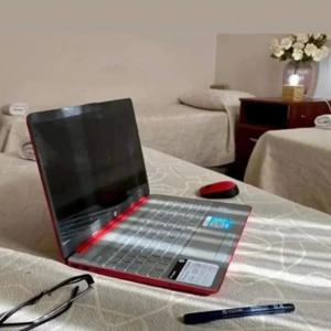 a laptop computer sitting on top of a table at KELMAN Hotel in Perito Moreno