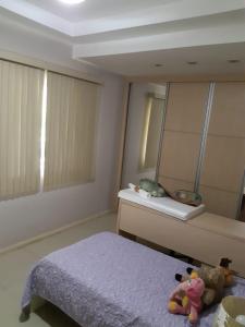 a bedroom with a bed and a mirror at Recanto do Galo in Volta Redonda +8 photos