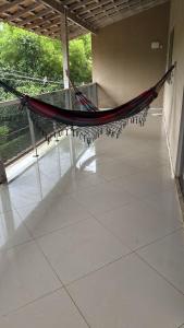 a hammock is hanging in a large room at Recanto do Galo in Volta Redonda
