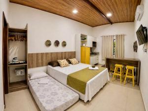 a bedroom with a bed and a table and chairs at Flats Morro de São Paulo in Morro de São Paulo +93 photos