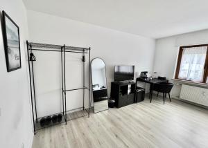 a white room with a desk and a mirror at PW38 Studio Koblenz in Koblenz
