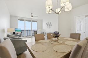 a dining room with a table and chairs and a television at Summerwind 1202C in Navarre