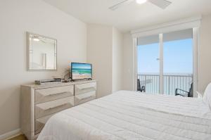 a white bedroom with a bed and a window at Summerwind 1202C in Navarre +40 photos