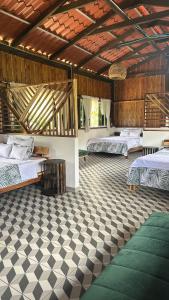 a room with two beds and a checkered floor at La Villa de los Alas - Boutique in Juayúa