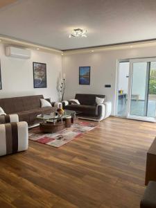 a living room with a couch and a table at Villa Una-Adi-Ela in Bihać