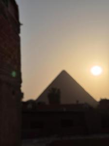 a pyramid with the sunset in the background at Hur palace pyramids view in Cairo +80 photos