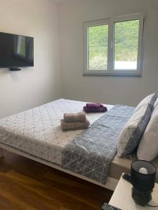 a bed in a bedroom with two pillows on it at Villa Una-Adi-Ela in Bihać +28 photos