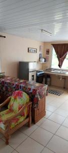 a kitchen with a table and a counter in a room at Heaiti Lodge in Avatoru