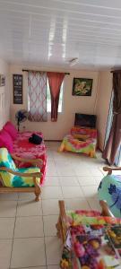 a room with three beds in a room at Heaiti Lodge in Avatoru