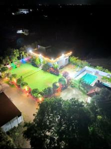 an aerial view of a house with a yard at night at Mir's Farm House in Hyderabad
