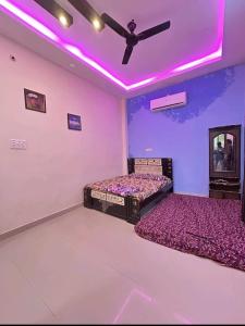 two beds in a room with a ceiling fan at Mir's Farm House in Hyderabad