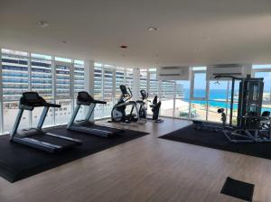 a gym with treadmills and exercise bikes in a building at Milateo Suite in Oranjestad