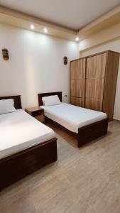 two beds in a room with two beds sidx sidx sidx sidx at The Palace Dahab in Dahab +9 photos