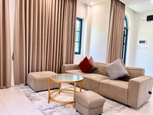 a living room with a couch and a table at Solara Coast Villa in Tiến Thành